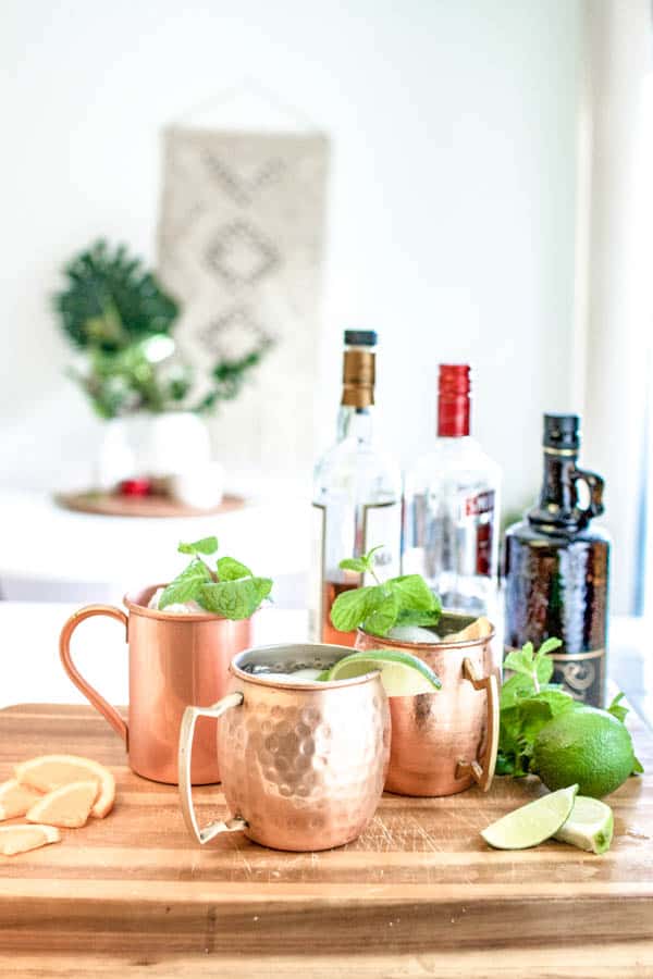 Moscow mule flavors in mugs next to whiskey and tequila and other flavors