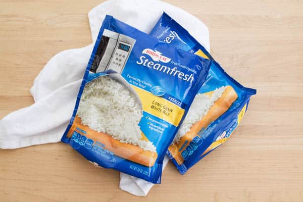 2 bags of microwave white rice on a counter. 