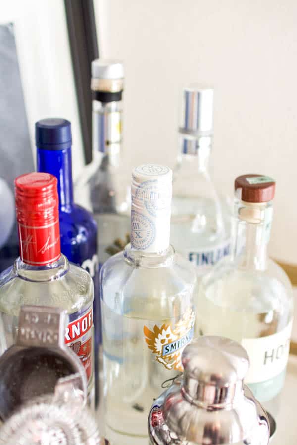 A close up of the tops of alcohol bottles.