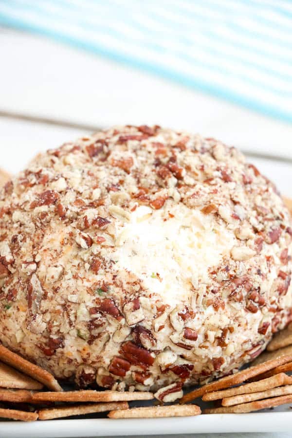 Easy ranch and chicken cheese ball on a plate with crackers.