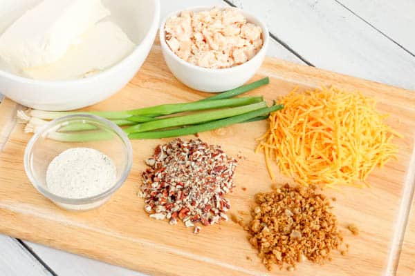 Ingredients for easy chicken and ranch cheese ball on a wooden cutting board.