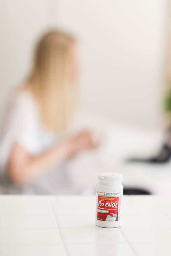 A bottle of Tylenol on a counter.