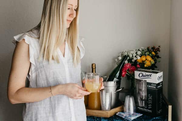 Girl holding a Chinet stemless wine glass holding a mimosa for brunch.