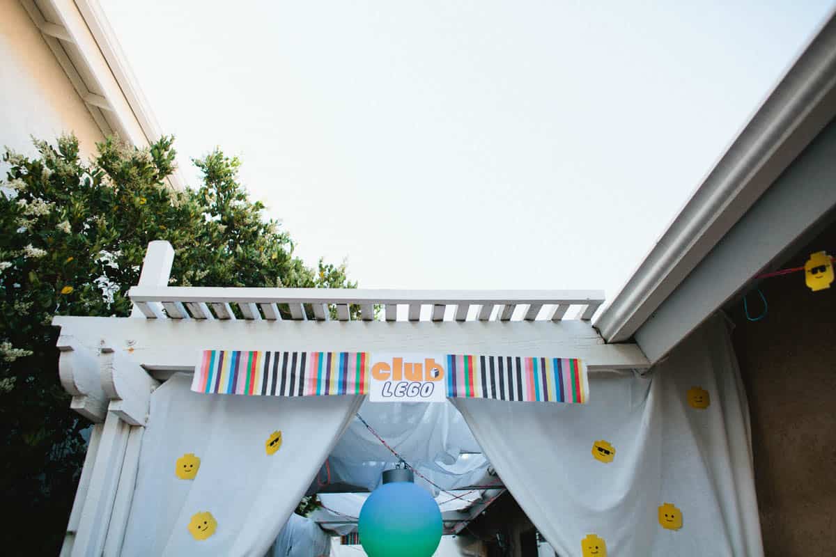 Patio decorated for a kid's birthday party with a Lego dance party theme. 