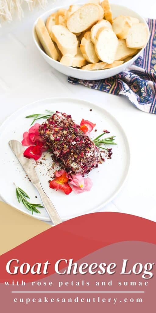 A white plate with a savory goat cheese log appetizer covered in dried rose petals with edible flowers around it.