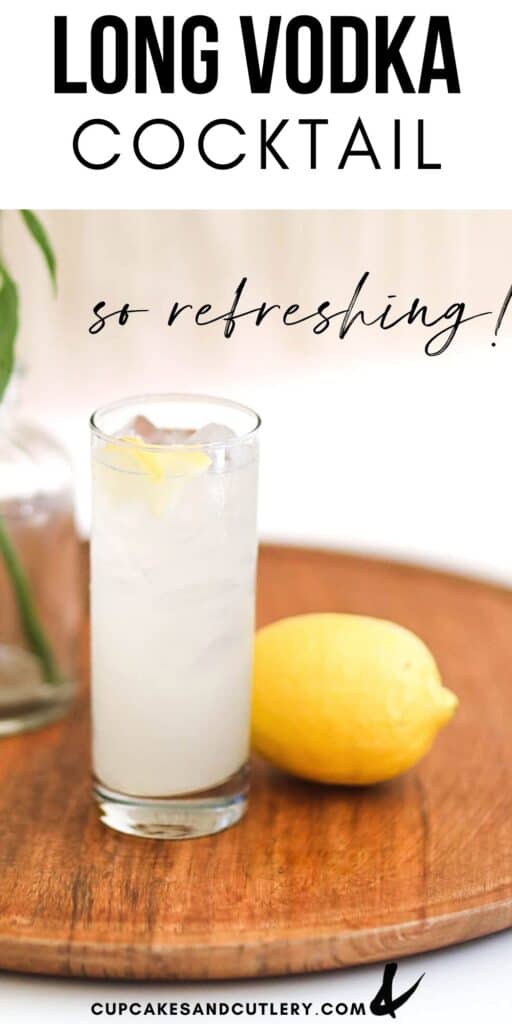 A Long Vodka cocktail on a wooden tray next to a lemon.