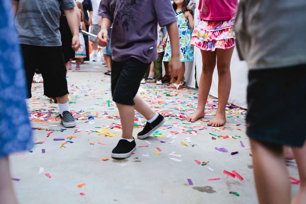 Kids feed dancing in confetti at a birthday party