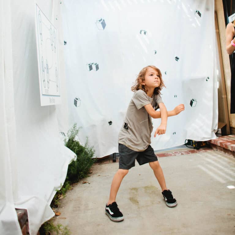 Kid dancing in a backyard club for his Lego Dance Party birthday.