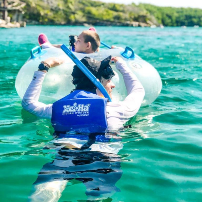 Father and son enjoy the river at Xel Ha.