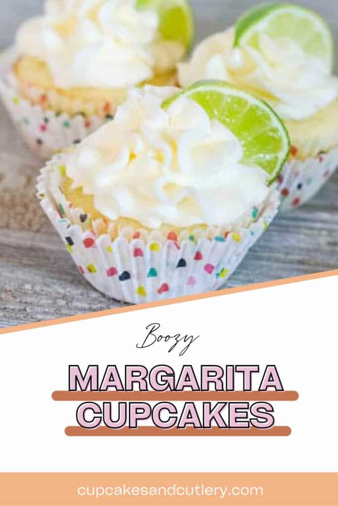Text: Boozy Margarita Cupcakes that are frosted and topped with lime wedges.