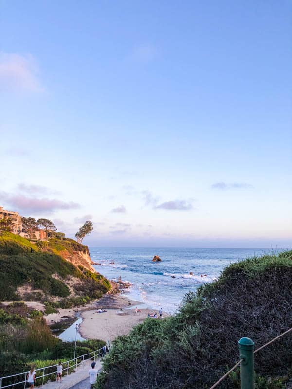 a photo of a beach cove at sunset.