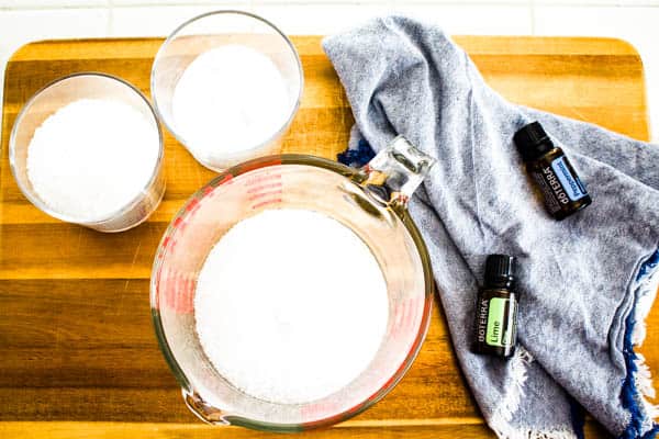 Glass bottles of the ingredients to make DIY bath salts. 