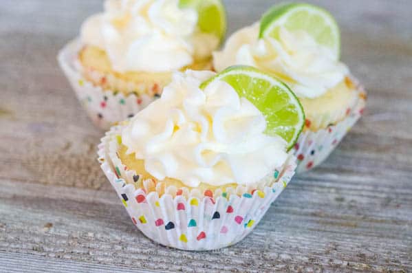 Margarita Cupcakes with tequila-infused buttercream on a wooden table. 