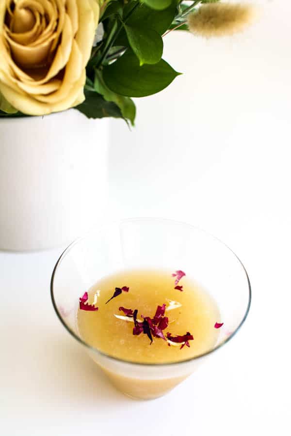 Pear vodka martini topped with edible flower confetti.
