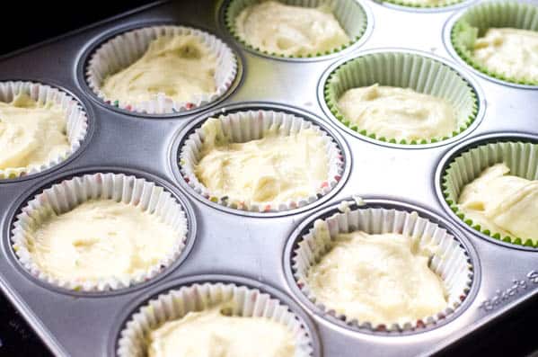 A cupcake pan with batter for Margarita Cupcakes in a cupcakes liners. 