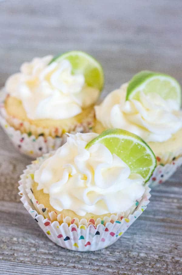 margarita cupcakes, frosted with Tequila lime buttercream in polka dot cupcakes liners sitting on a table.  