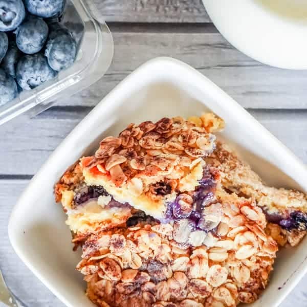 A portion of Peach and Blueberry Dump Cake toped with cake mix crust and oat meal. 