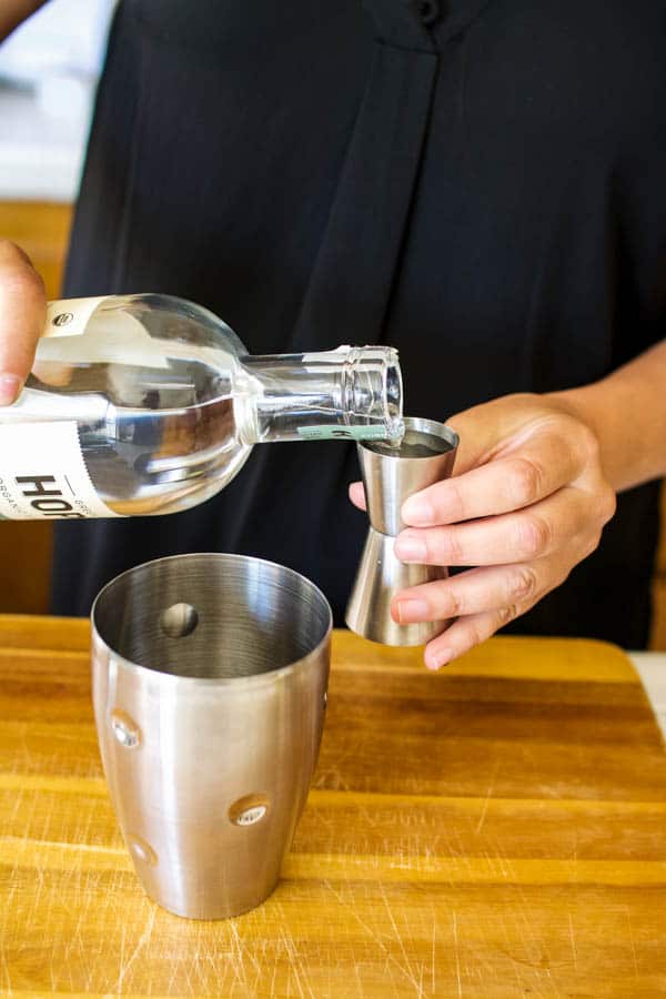 Pouring vodka for a cocktail recipe.