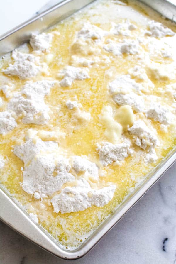 Powdered cake mix with melted butter poured on top for a dump cake.