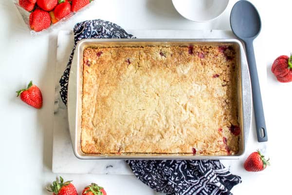 Finished strawberry dump cake on a table. 