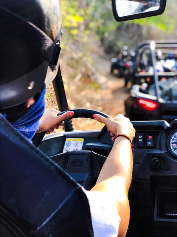 Woman driving an off road ATV in the desert in Mexico.