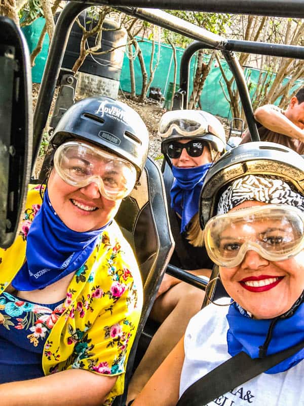 Women in helmets and goggles in on off road ATV in Mexico.