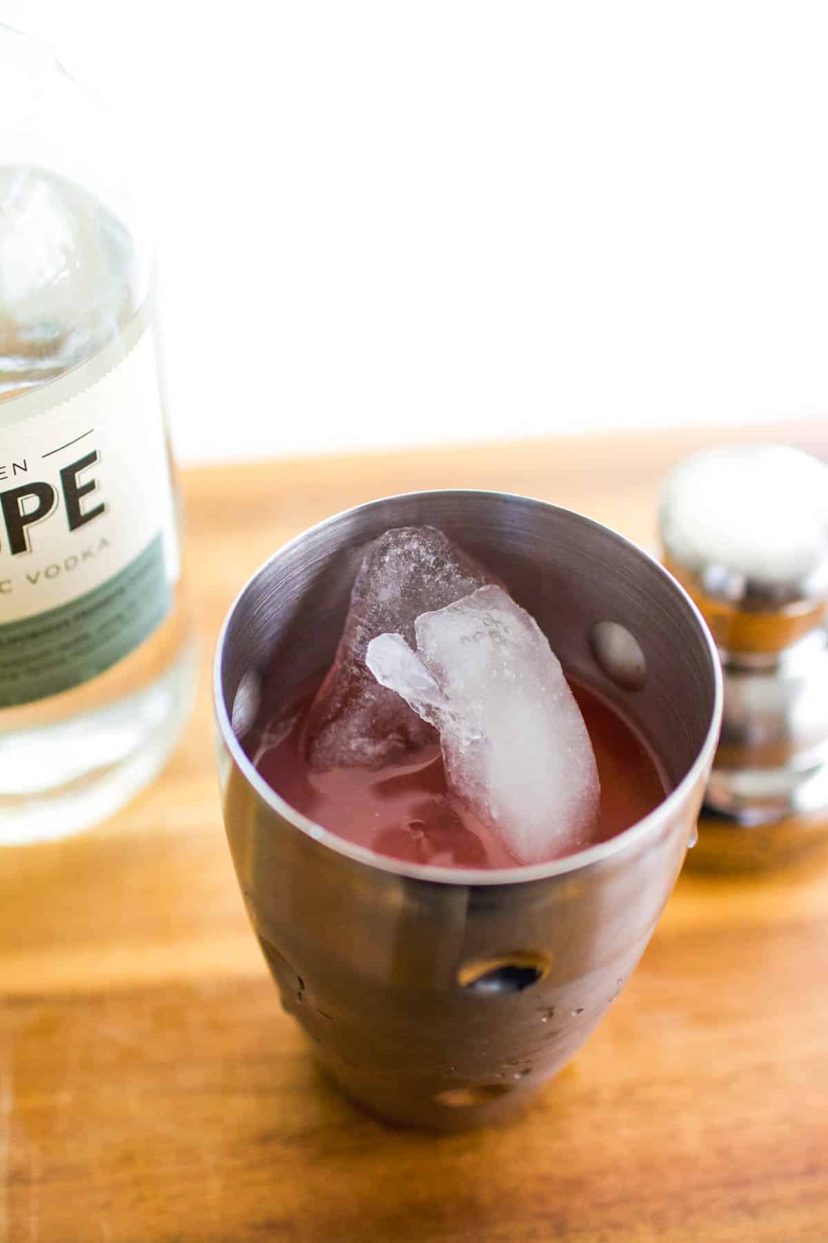 Close up of ice and fruit punch in a cocktail shaker.