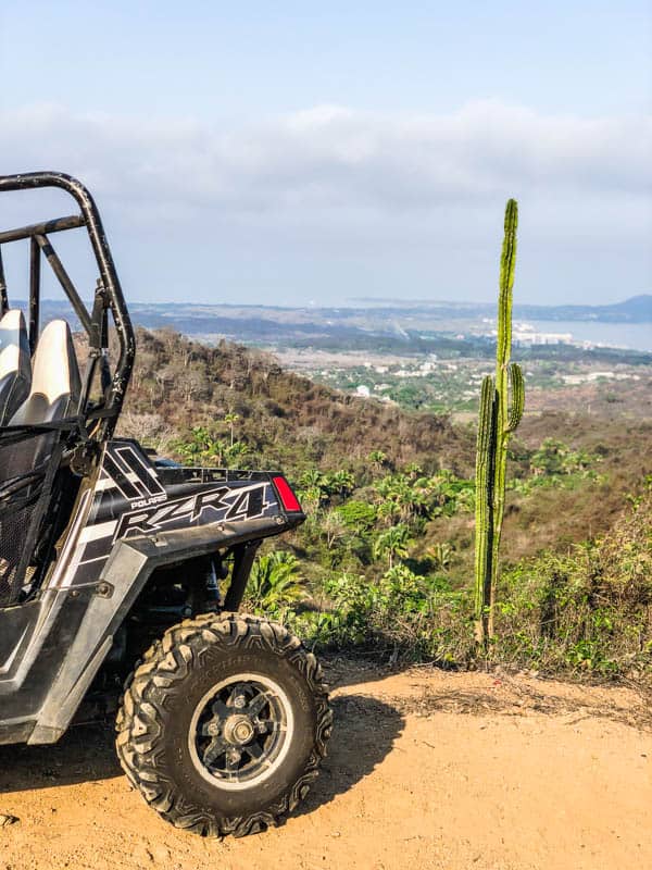 The back portion of an ATV with a view of Mexico behind it.