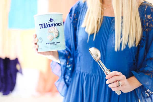 girl holding tillamook ice cream and an ice cream scooper