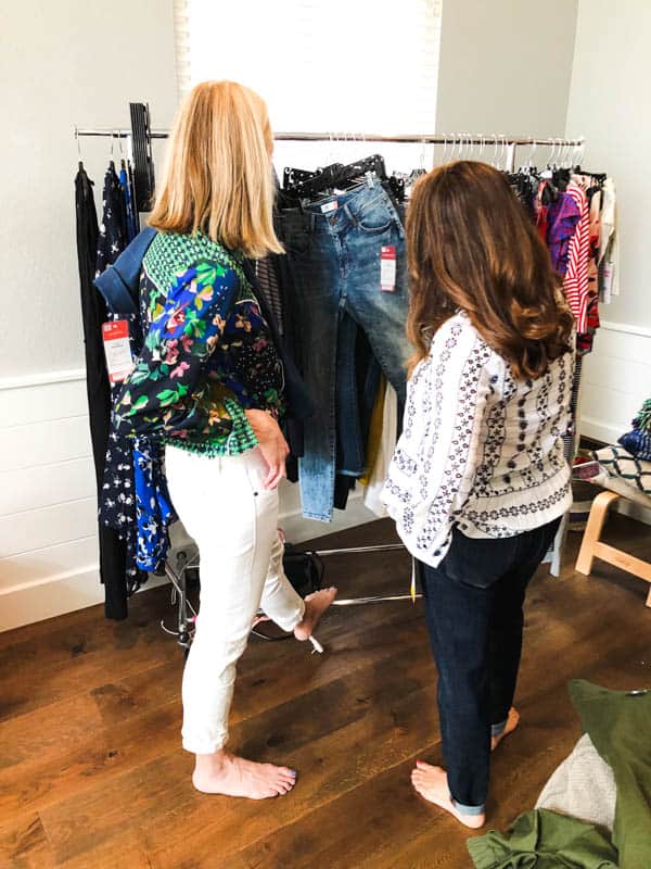 women looking at a rack of clothing