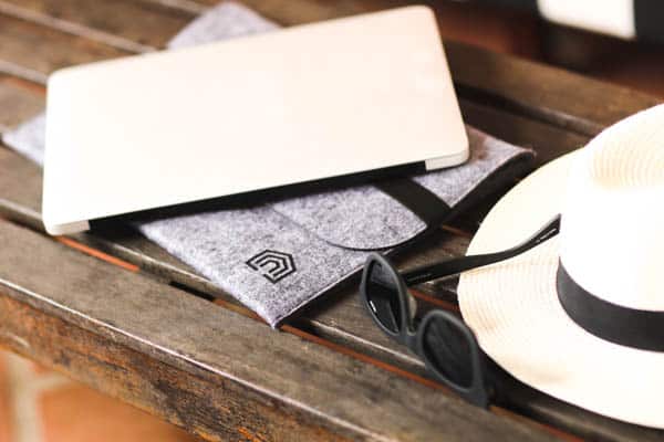 laptop computer on a table with a hat and sunglasses