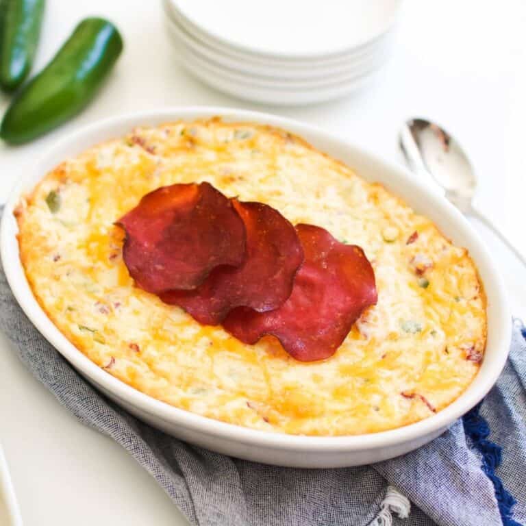 Close up of a baked Jalapeno Cream Cheese Dip on a table.