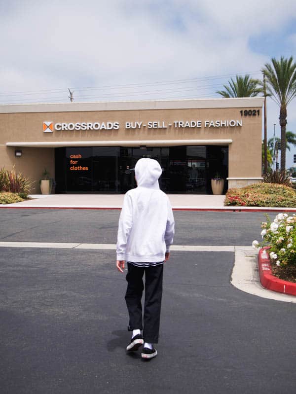Teen boy walking into Crossroads Trading Huntington Beach