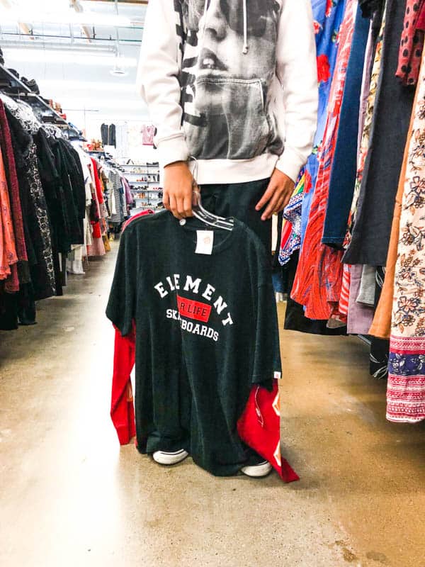 Teen boy holding brand name tshirt