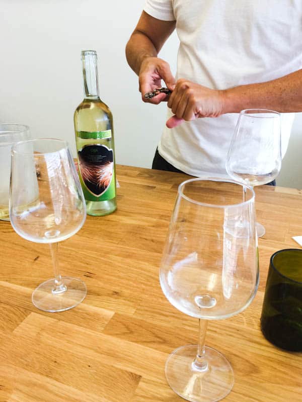 Man turning a wine corkscrew for a wine tasting.
