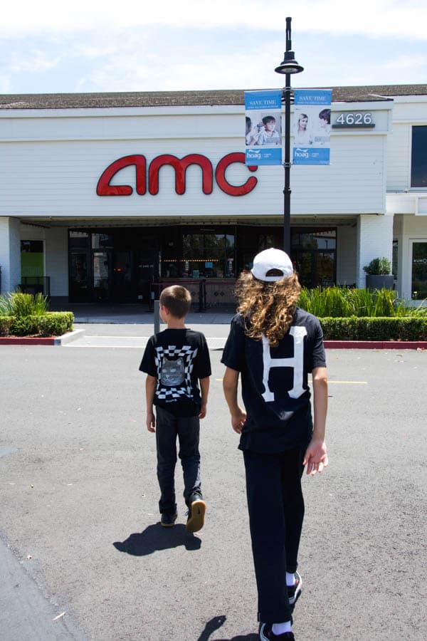 Two boys walking up to the AMC theater at Woodbridge Village Center.