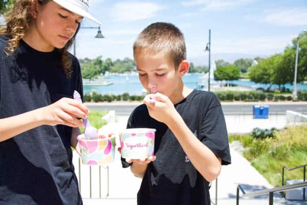 Kids eating Yogurtland at Woodbridge Center with North lake behind them. 