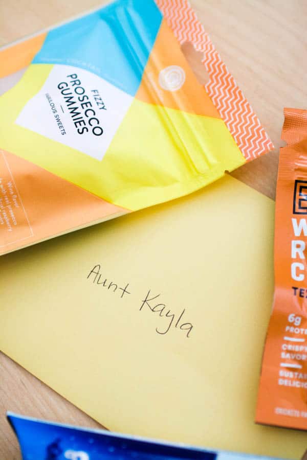 An envelope with a name on it next to some candy packages