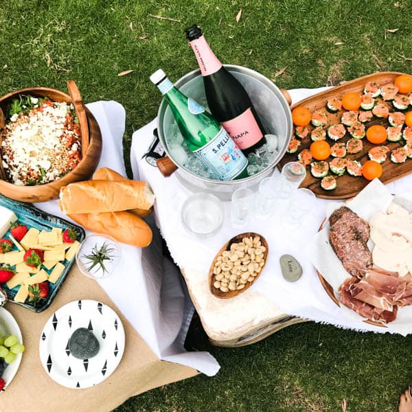 Picnic set up on a low table on grass.
