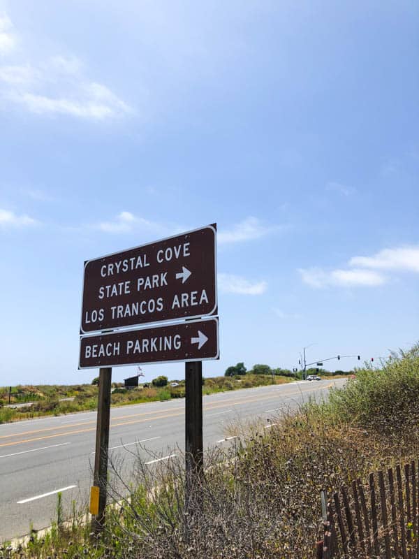 Sign for Crystal Cove State Beach by the side of the road