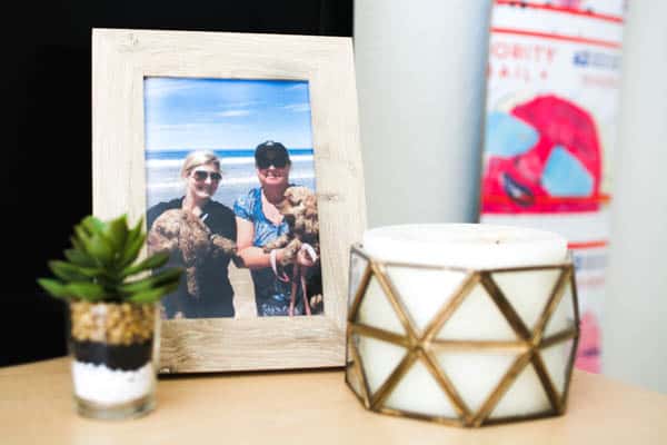 A framed photo and candle on a table