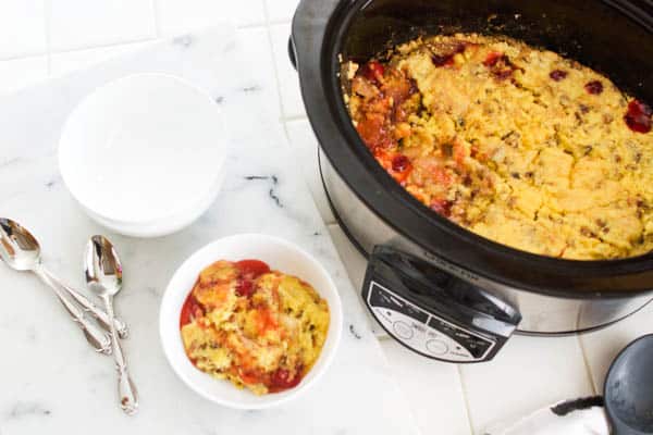 Making apple dump cake in a slow cooker with cherry pie filling.