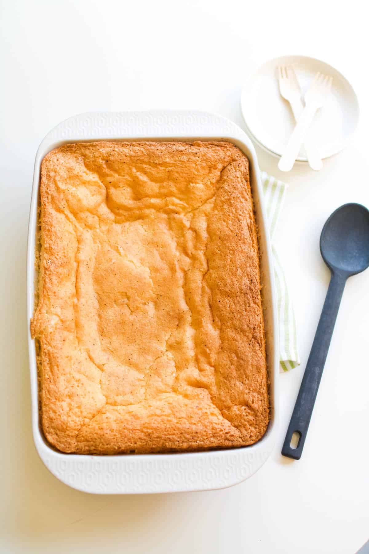 A baking dish with baked angel food cake on top of a dump cake.