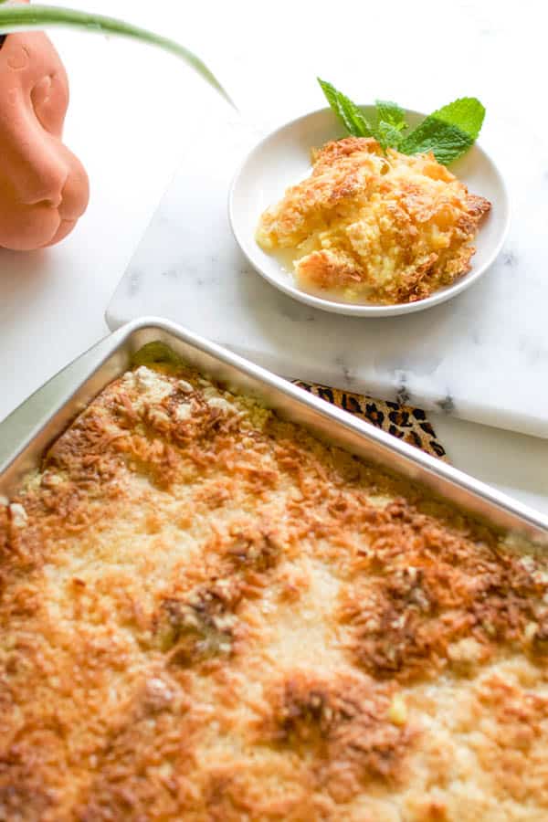 Condensed milk dump cake with pineapple and coconut in a small bowl. 