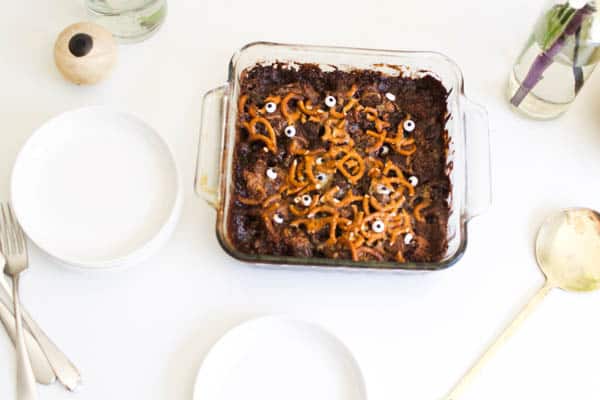 Halloween Dump Cake with candy eyes and pretzels on a table. 