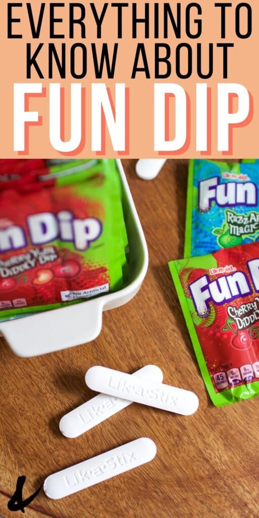 White candy sticks and Fun Dip packets on a wooden tray.