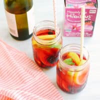 Hibiscus tea sangria in jars with straws.