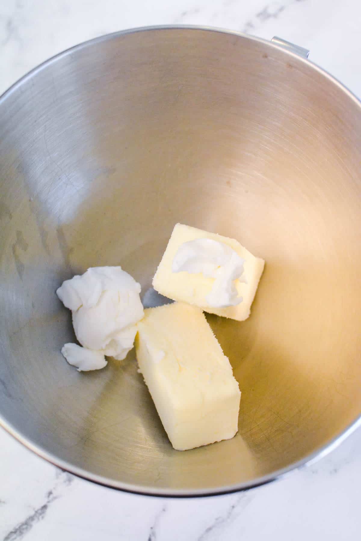 Butter and vegetable shortening in the bowl of a stand mixer.