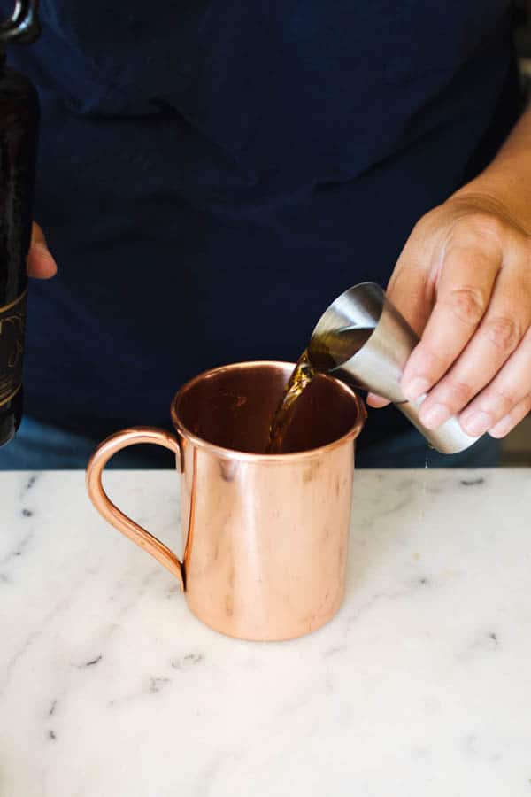Pouring in rum for Moscow mule.