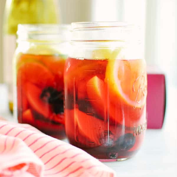 Sangria with fresh fruit in jars.